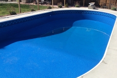 Aurora oval shaped pool remodel, featuring a new deck, coping, wall refurbishing and custom liner