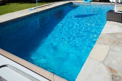 Predera pool, complete design and installation, featuring custom stone deck, custom liner and automatic CoverStar Cover